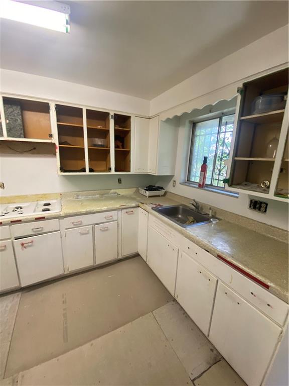 2525 Webster Avenue Pittsburgh, PA 15219 - Photo 8 of 11 a kitchen with granite countertop a sink and a stove