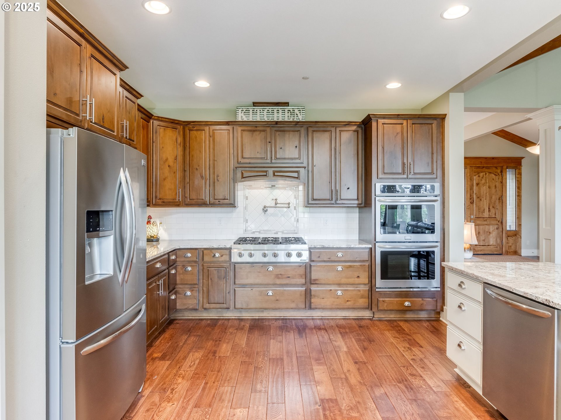 20321 Olmstead Road Northeast Aurora, OR 97002 - Photo 20 of 45 a kitchen with granite countertop stainless steel appliances and wooden cabinets