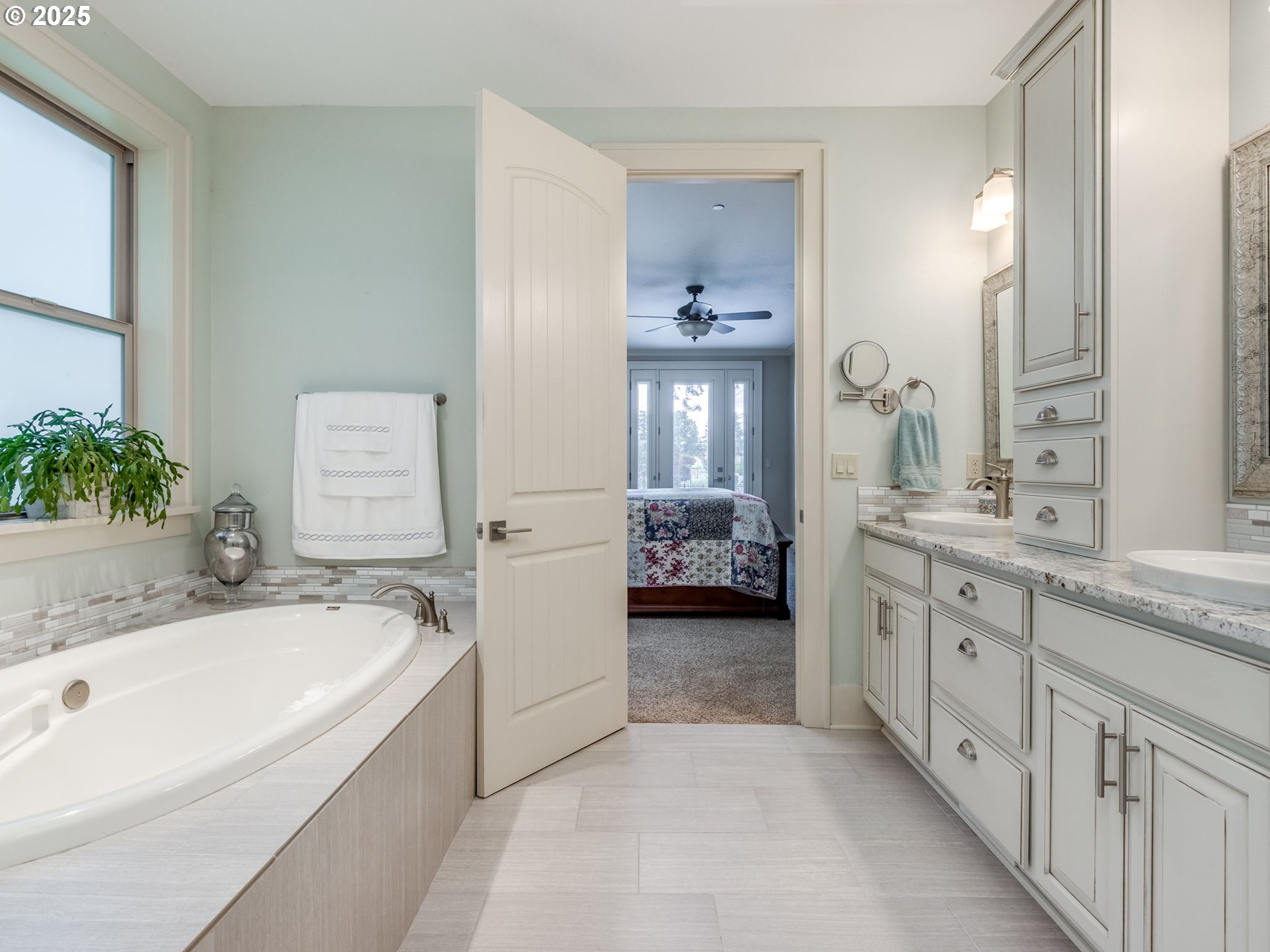 20321 Olmstead Road Northeast Aurora, OR 97002 - Photo 28 of 45 a spacious bathroom with a tub sink and mirror