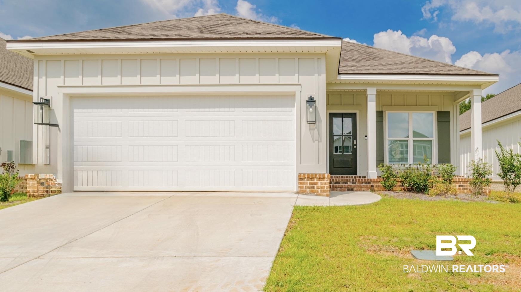 655 H Norman Lane Fairhope, AL 36532 - Photo 1 of 30 View of front of house with a garage and a front lawn