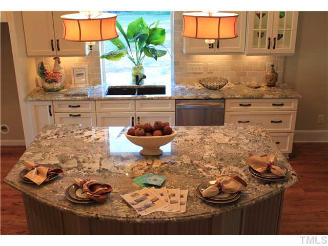 4909 Great Meadows Court Raleigh, NC 27609 - Photo 17 of 25 Huge island/ dining area with level 5 granite. Kitchen