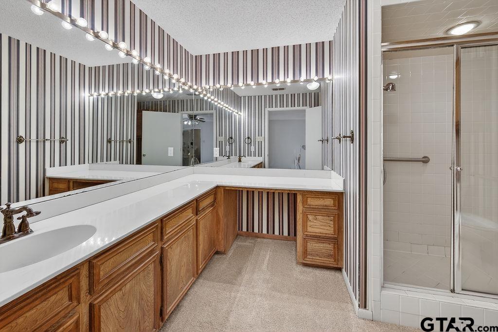 1111 Hillside Drive Athens, TX 75751 - Photo 13 of 20 a bathroom with a double vanity sink and a mirror