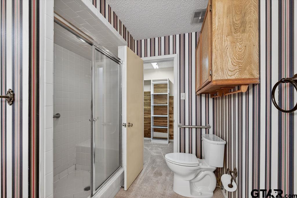 1111 Hillside Drive Athens, TX 75751 - Photo 14 of 20 a bathroom with a toilet and a shower
