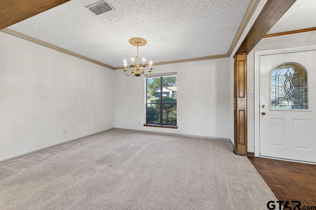 1111 Hillside Drive Athens, TX 75751 - Photo 6 of 20 en empty room with windows and chandelier