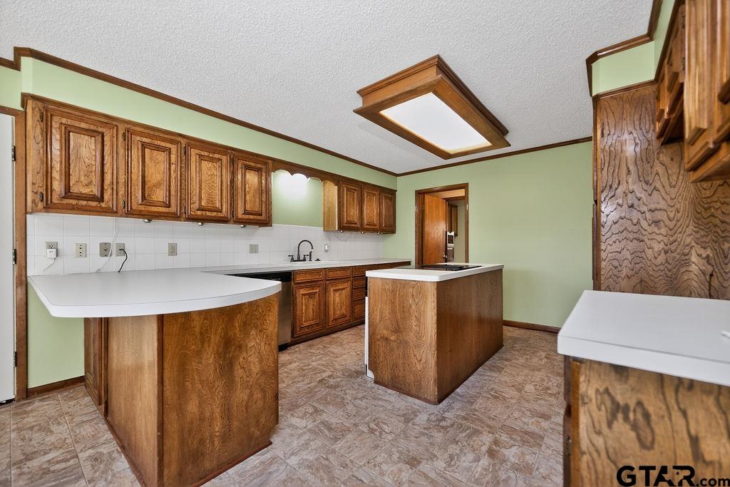 1111 Hillside Drive Athens, TX 75751 - Photo 7 of 20 a kitchen with stainless steel appliances granite countertop a sink counter space and a window