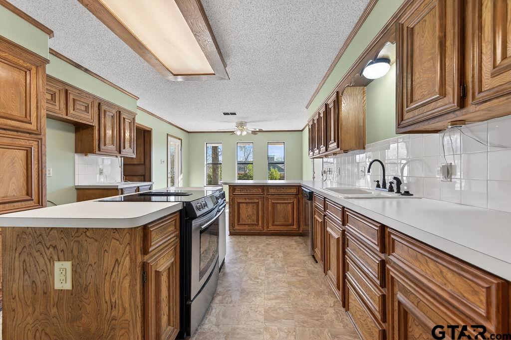 1111 Hillside Drive Athens, TX 75751 - Photo 8 of 20 a kitchen with stainless steel appliances granite countertop a stove and a sink