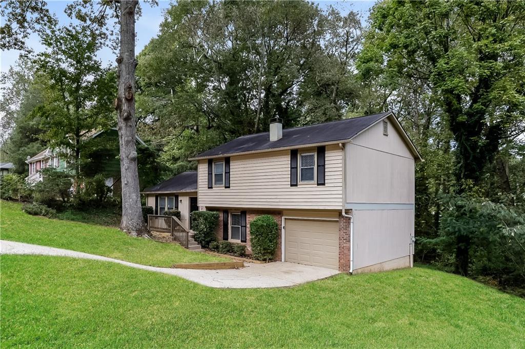 3352 Herrenhut Road Lithonia, GA 30038 - Photo 2 of 27 a view of a house with a yard and sitting area