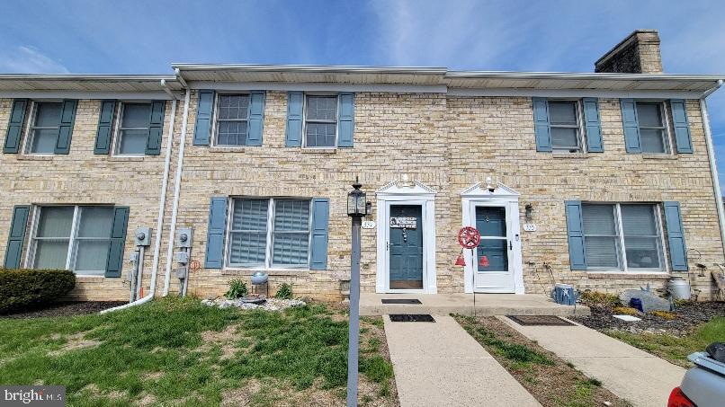 a front view of a house with plants
