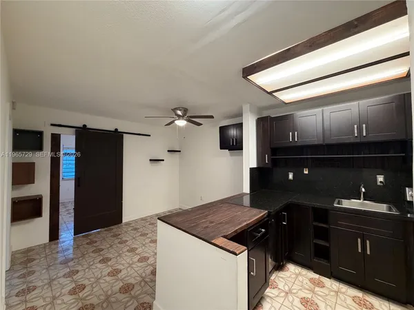 a kitchen with a stove and a refrigerator