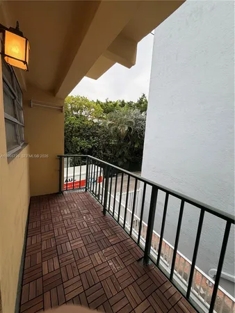 a view of a balcony with wooden floor