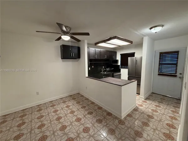 a kitchen with a stove and a refrigerator