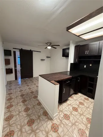 a living room with a bed and a television