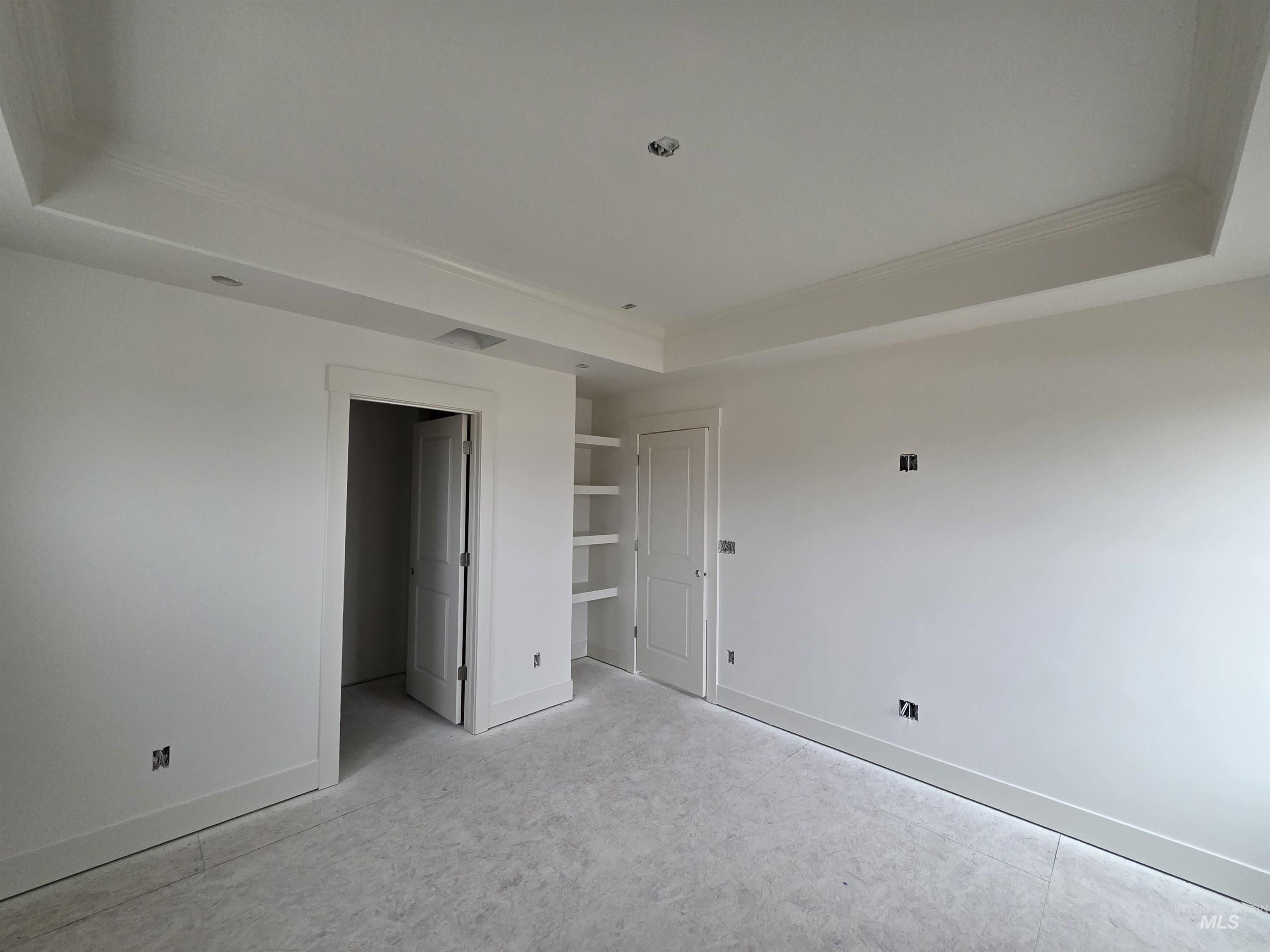 1504 Tverdy Lane Buhl, ID 83316 - Photo 6 of 12 Unfurnished bedroom with a tray ceiling, ornamental molding, and a spacious closet