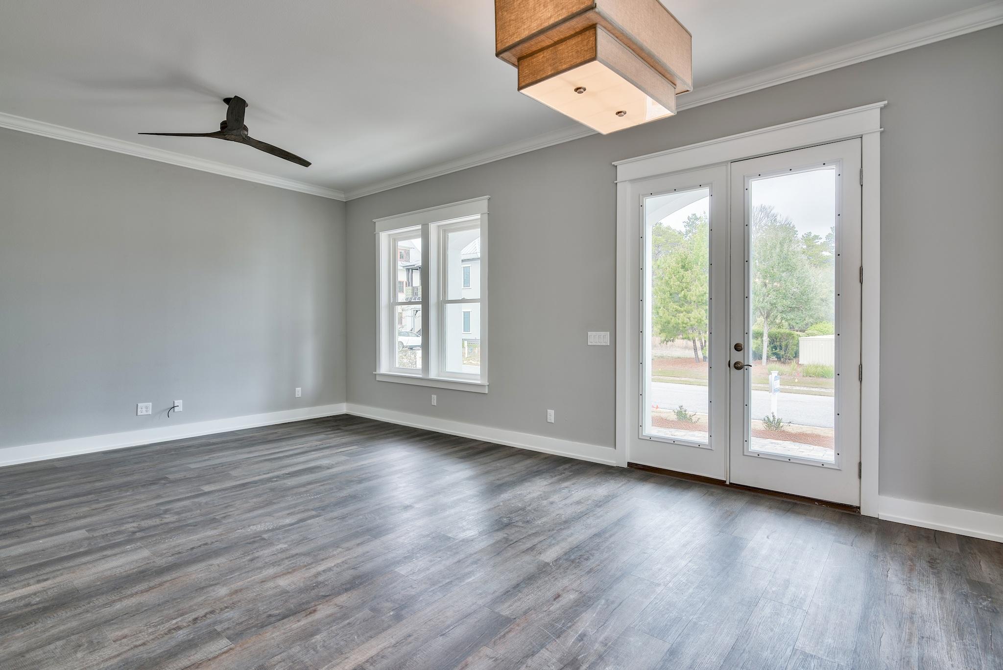 Lot 29 West Willow Mist Rd Inlet Beach Inlet Beach, FL 32461 - Photo 5 of 28 an empty room with wooden floor fan and windows