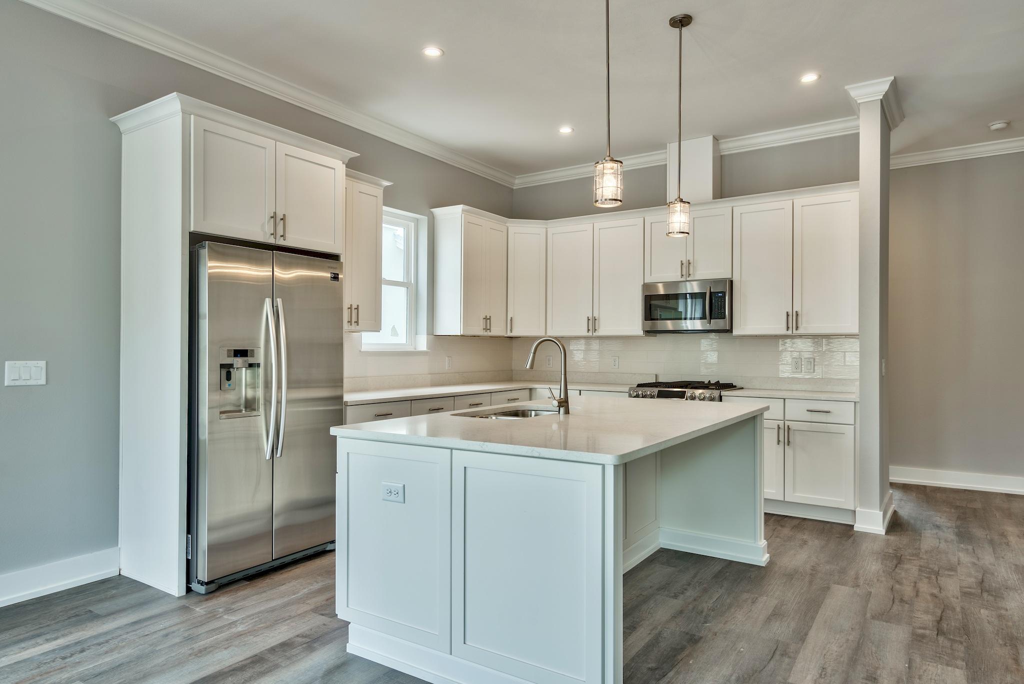 Lot 29 West Willow Mist Rd Inlet Beach Inlet Beach, FL 32461 - Photo 8 of 28 a kitchen with stainless steel appliances granite countertop a sink a stove a refrigerator and island with wooden floor