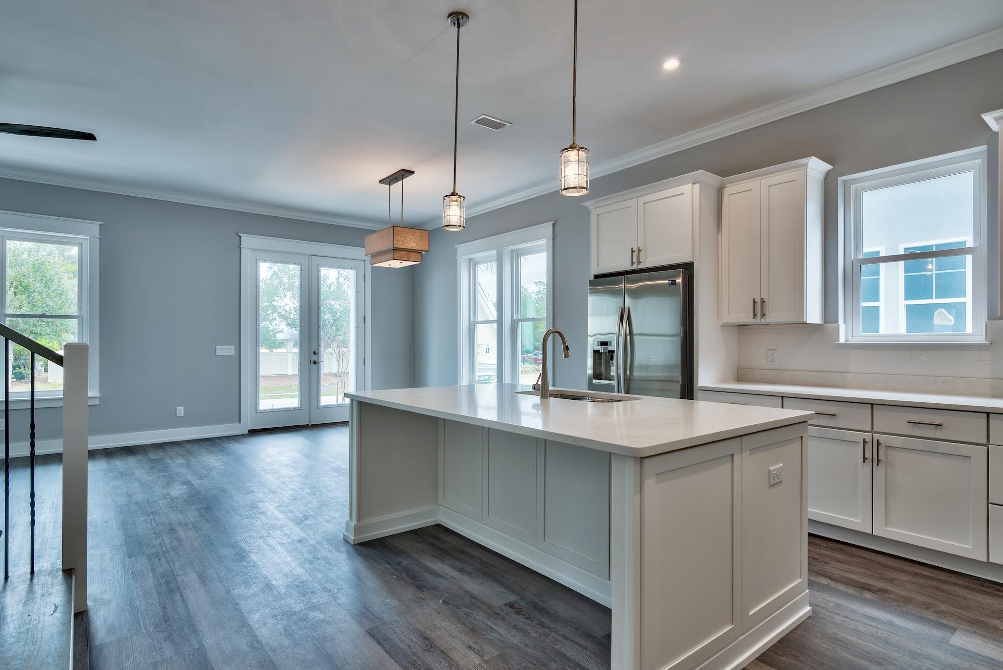 Lot 29 West Willow Mist Rd Inlet Beach Inlet Beach, FL 32461 - Photo 10 of 28 a large kitchen with stainless steel appliances granite countertop a sink a window and wooden floors
