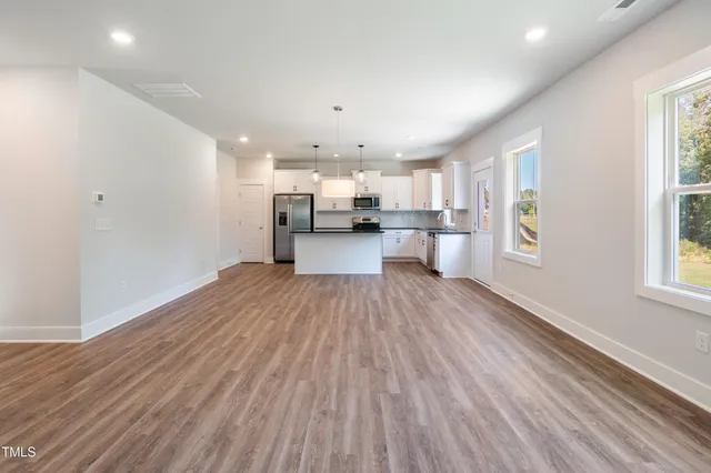 a view of a kitchen with a sink and wooden floor