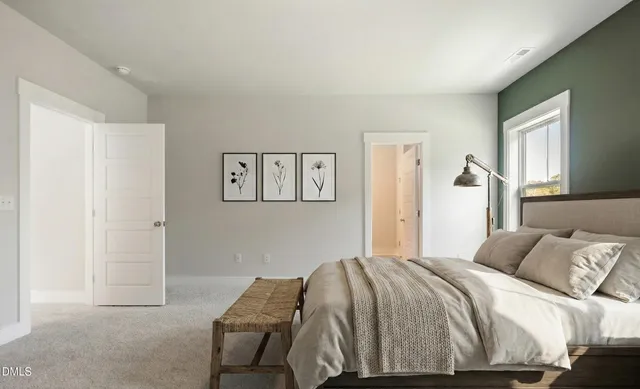 a bedroom with a bed and painting on the wall