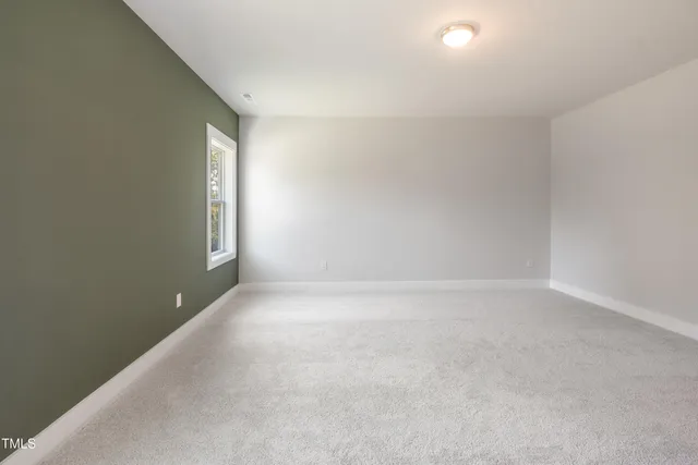 a bathroom with a granite countertop toilet a sink and a mirror