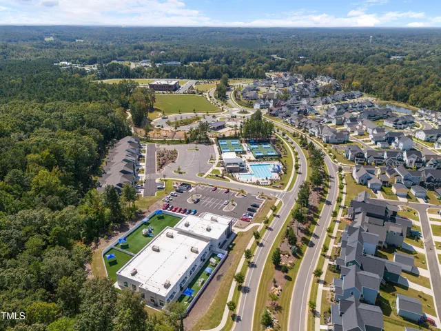 an aerial view of a house with a yard