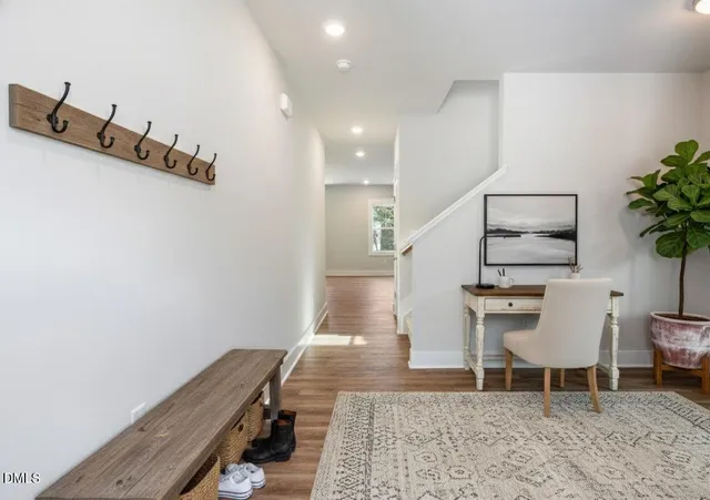 a hallway with a table and chairs