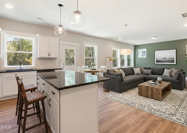 a living room with granite countertop kitchen island furniture and a large window