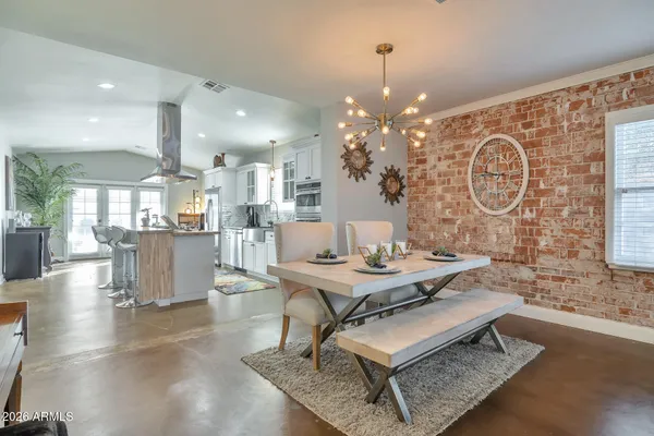 a living room with dining table and chairs
