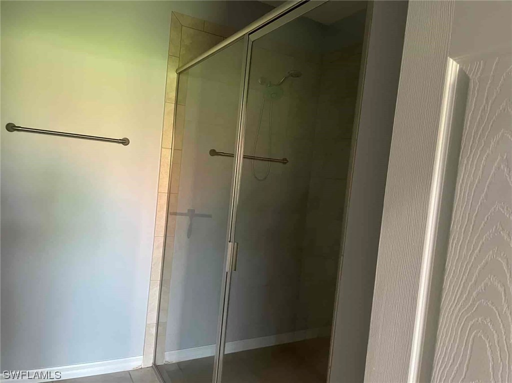 4369 Dutchess Park Road Fort Myers, FL 33916 - Photo 16 of 18 a bathroom with a glass shower door