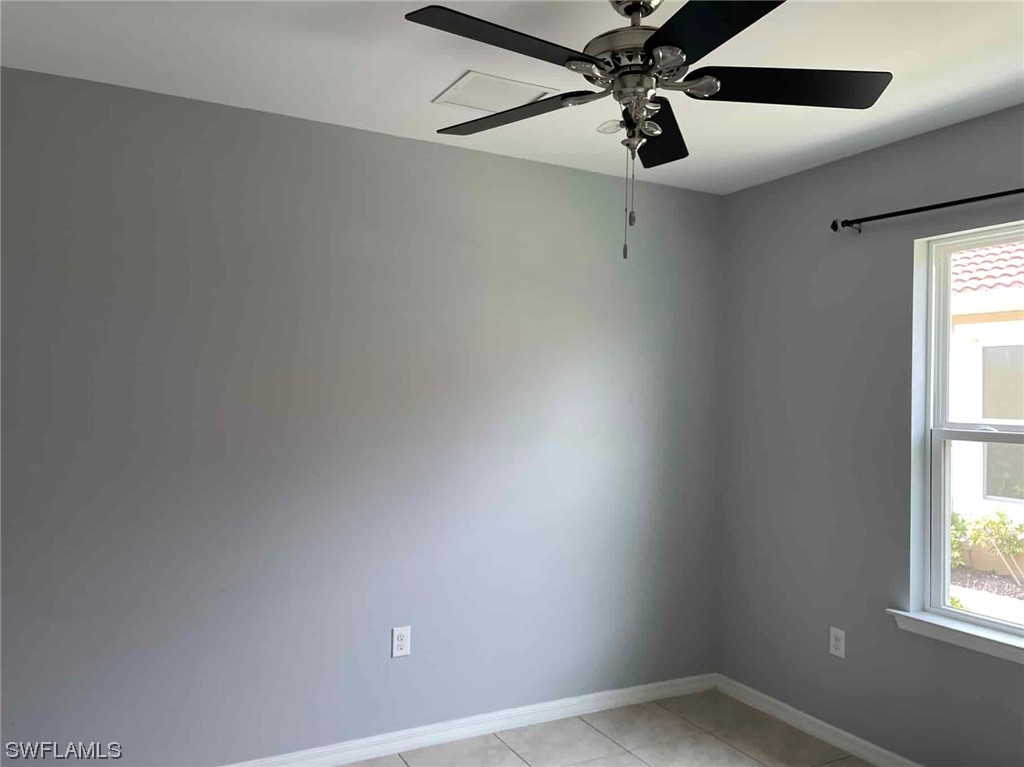 4369 Dutchess Park Road Fort Myers, FL 33916 - Photo 4 of 18 an empty room with a window and a fan