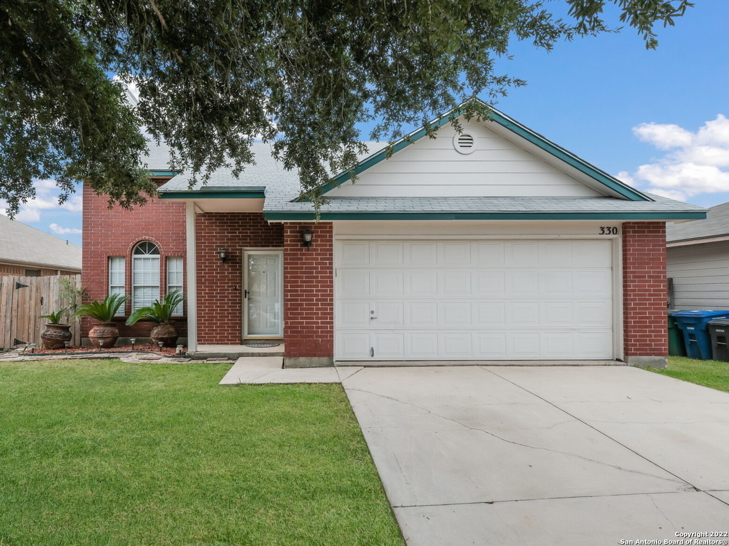 330 La Garde Street San Antonio, TX 78223 - Photo 1 of 23 a front view of a house with a yard and garage