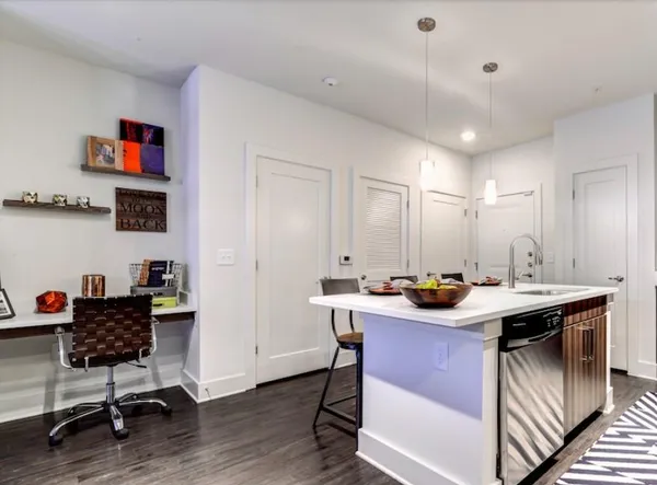 a view of a workspace with furniture and wooden floor