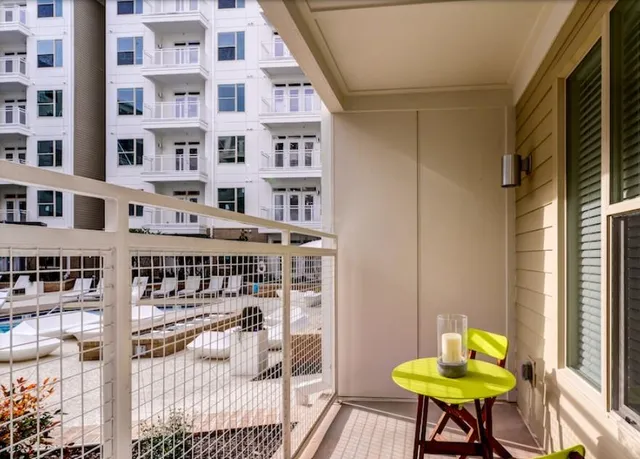 a chair and a table in a livingroom with wooden floor