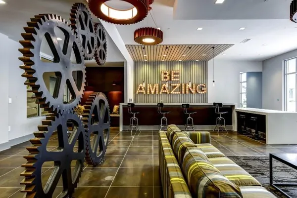 a living room with furniture a flat screen tv and kitchen view
