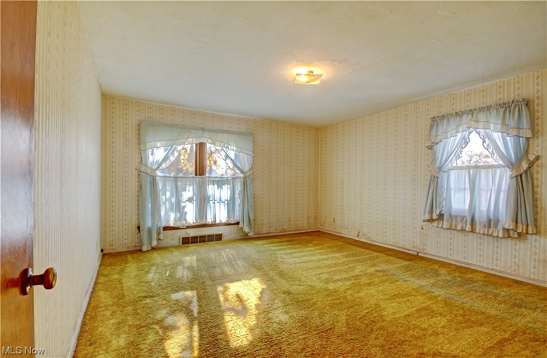 20930 Eaton Road Cleveland, OH 44126 - Photo 24 of 33 Empty room with light colored carpet and a healthy amount of sunlight