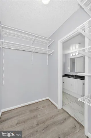 a view of a bathroom with a sink a mirror and a bathtub