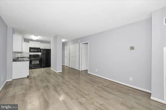 a view of kitchen with refrigerator and microwave