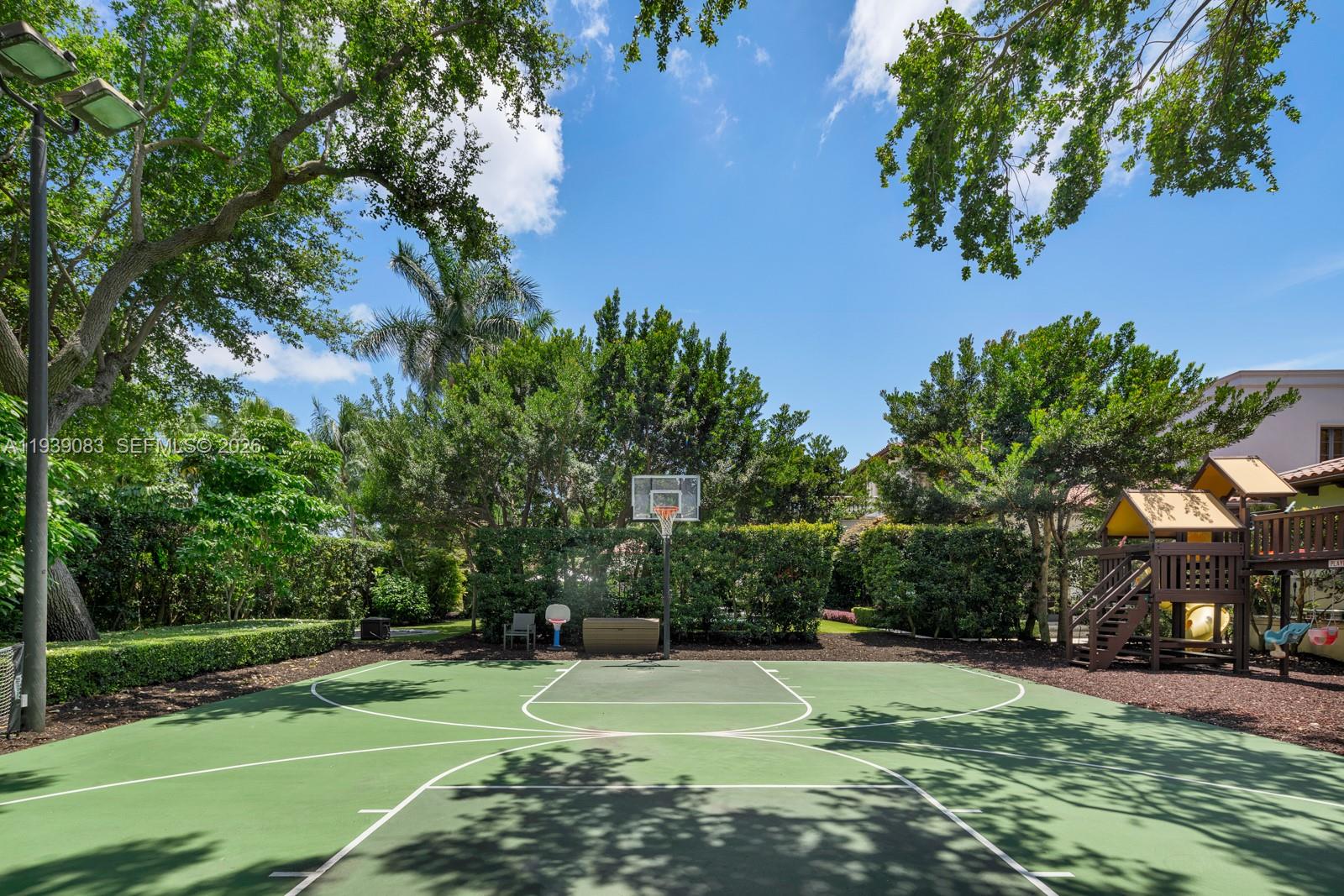 7275 Old Cutler Road Coral Gables, FL 33143 - Photo 18 of 21 a view of a tennis ground with large trees