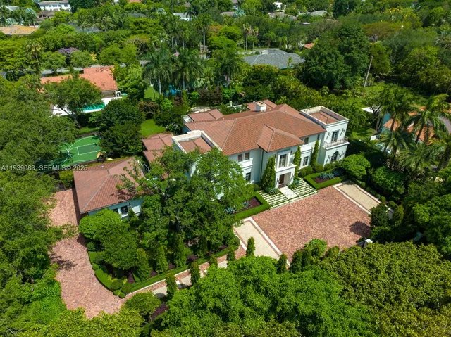 an aerial view of a house with yard and outdoor seating