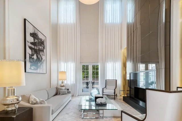 a living room with furniture and large window