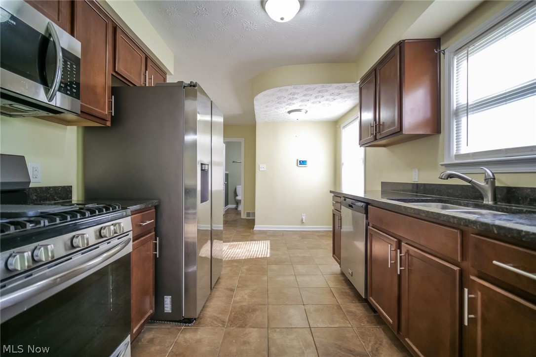 736 Quilliams Road Cleveland Heights, OH 44121 - Photo 8 of 20 Kitchen with plenty of natural light, sink, stainless steel appliances, and light tile floors
