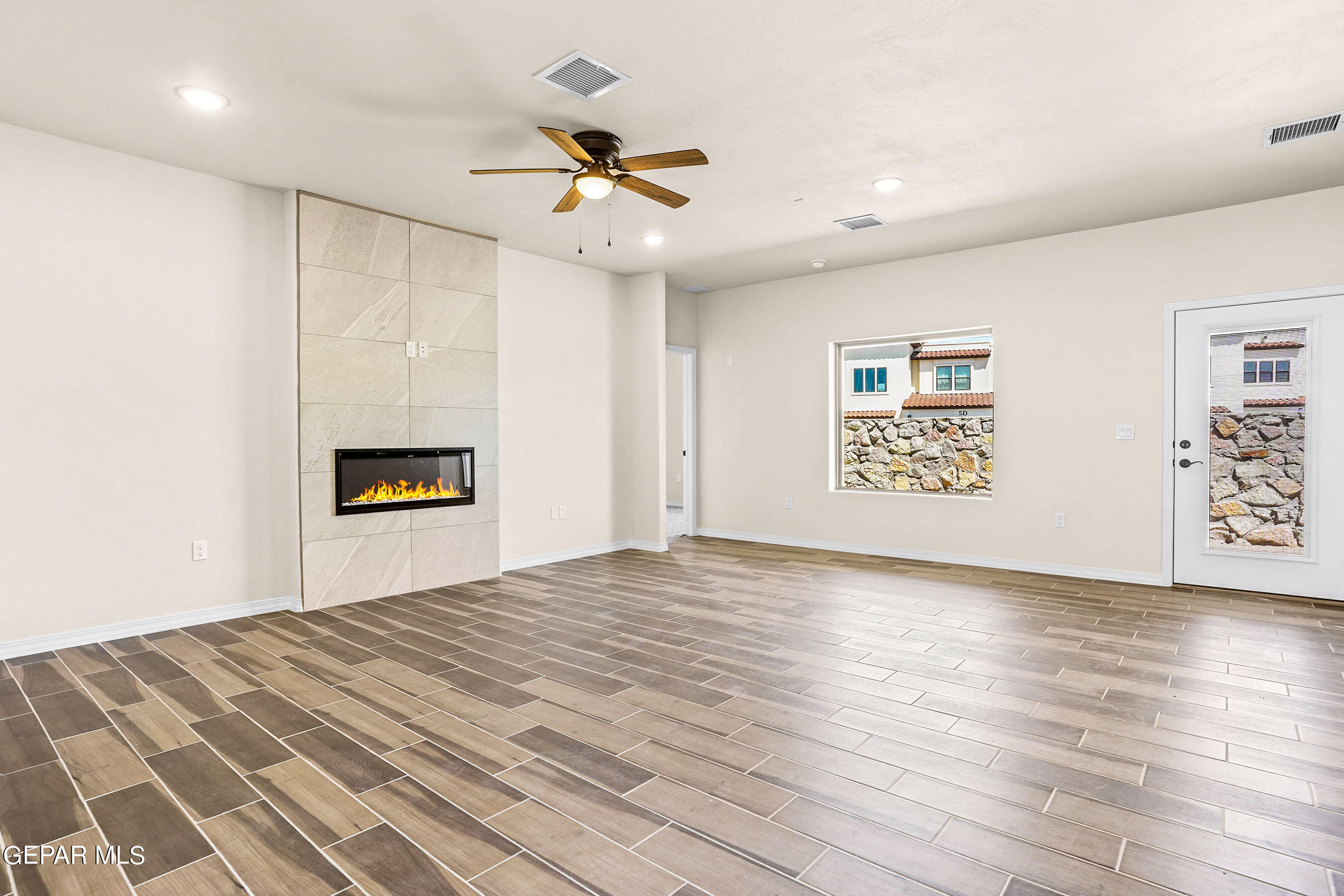 871 Country Club Road, Unit 4E El Paso, TX 79932 - Photo 3 of 34 a view of empty room with wooden floor and fan