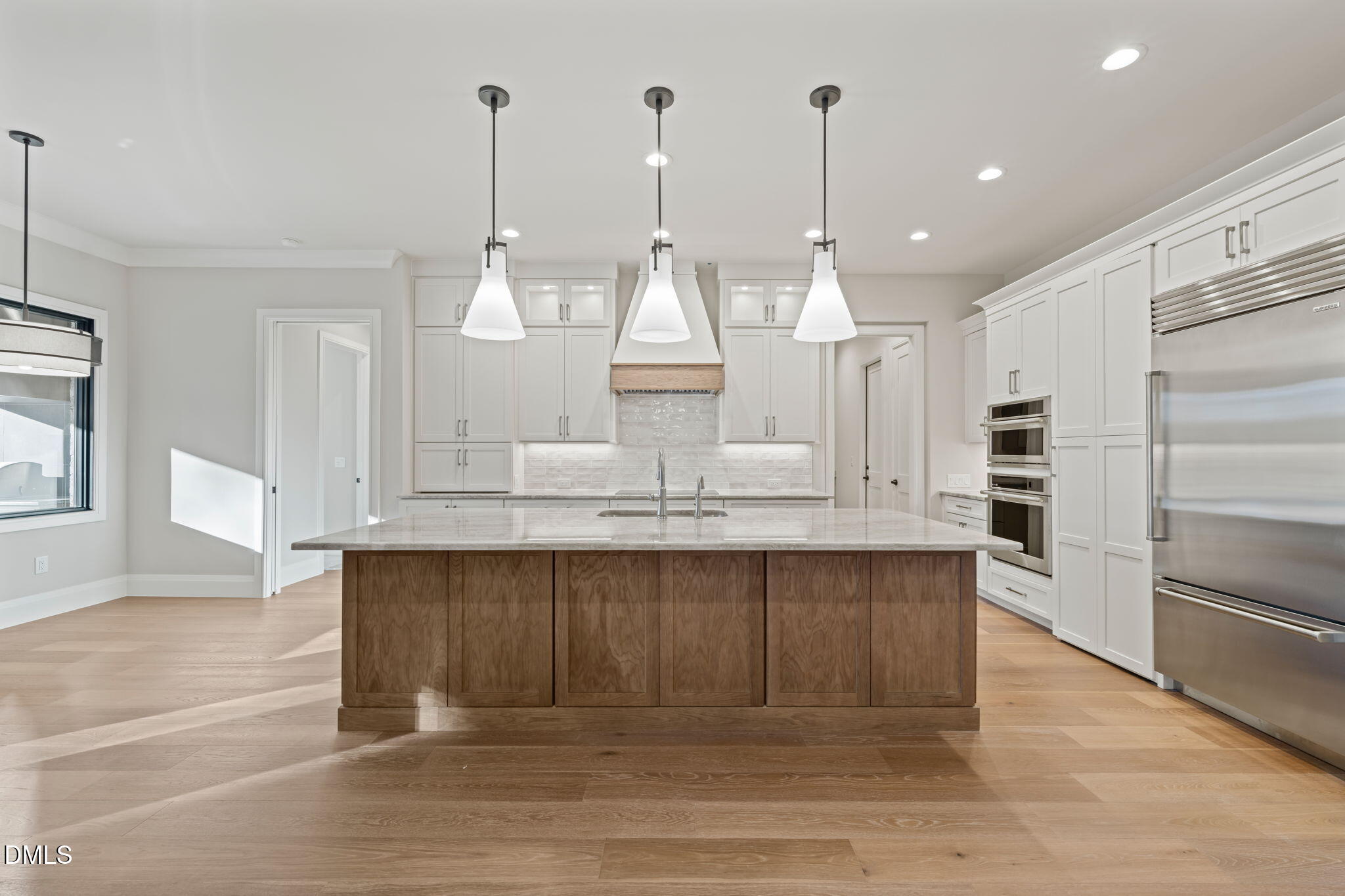 9125 Overlook Crest Drive Wake Forest, NC 27587 - Photo 19 of 54 a kitchen with kitchen island granite countertop a sink cabinets and stainless steel appliances