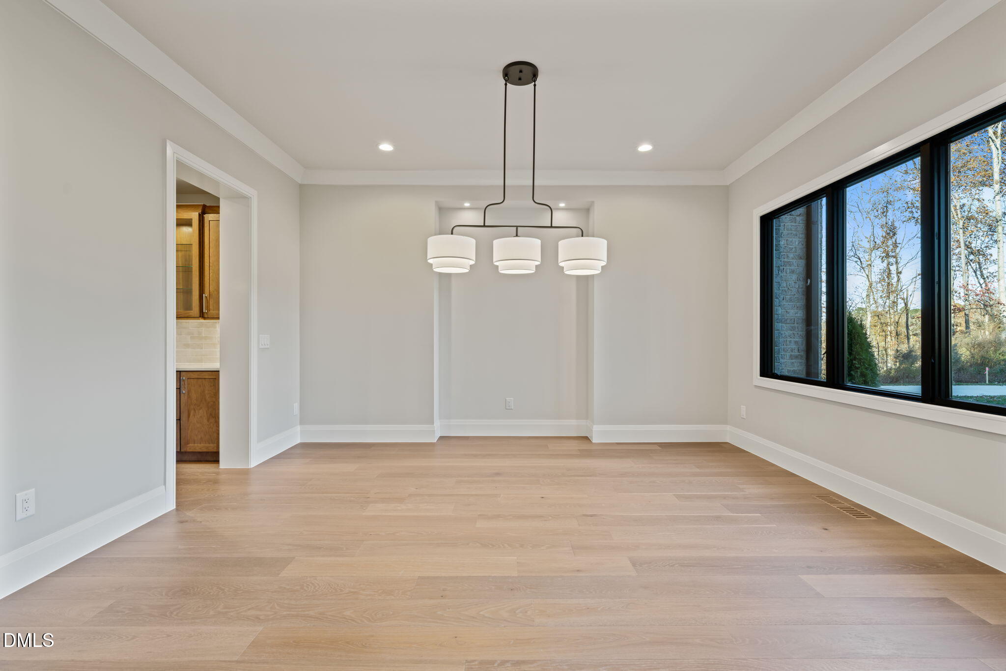 9125 Overlook Crest Drive Wake Forest, NC 27587 - Photo 4 of 54 a view of an empty room with window and chandelier