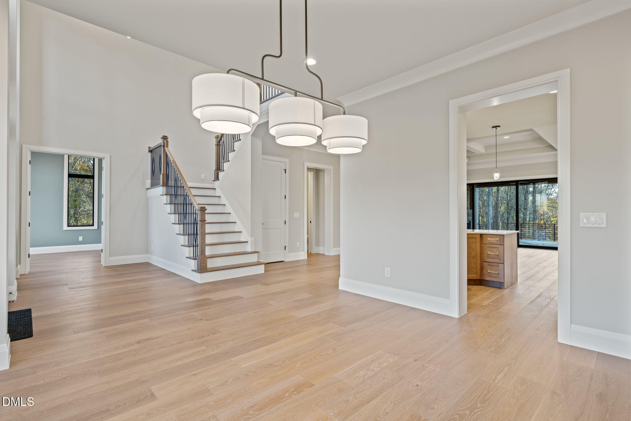 9125 Overlook Crest Drive Wake Forest, NC 27587 - Photo 5 of 54 a view of a livingroom with wooden floor staircase and kitchen view