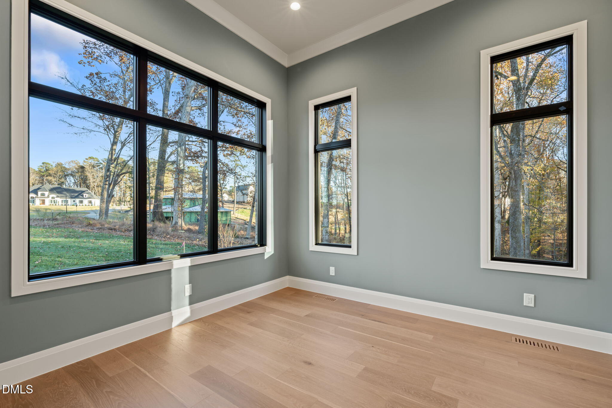 9125 Overlook Crest Drive Wake Forest, NC 27587 - Photo 7 of 54 a view of an empty room with wooden floor and a window