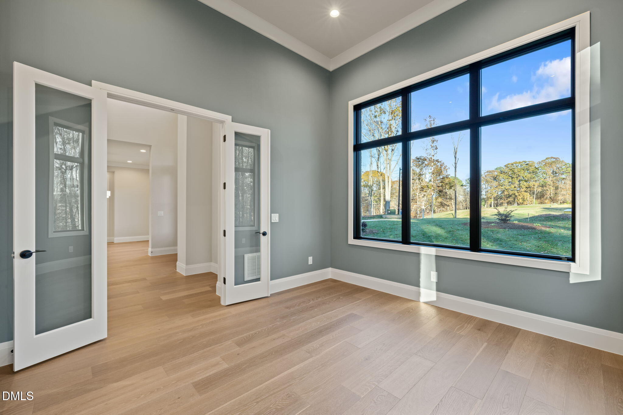 9125 Overlook Crest Drive Wake Forest, NC 27587 - Photo 8 of 54 an empty room with wooden floor and windows