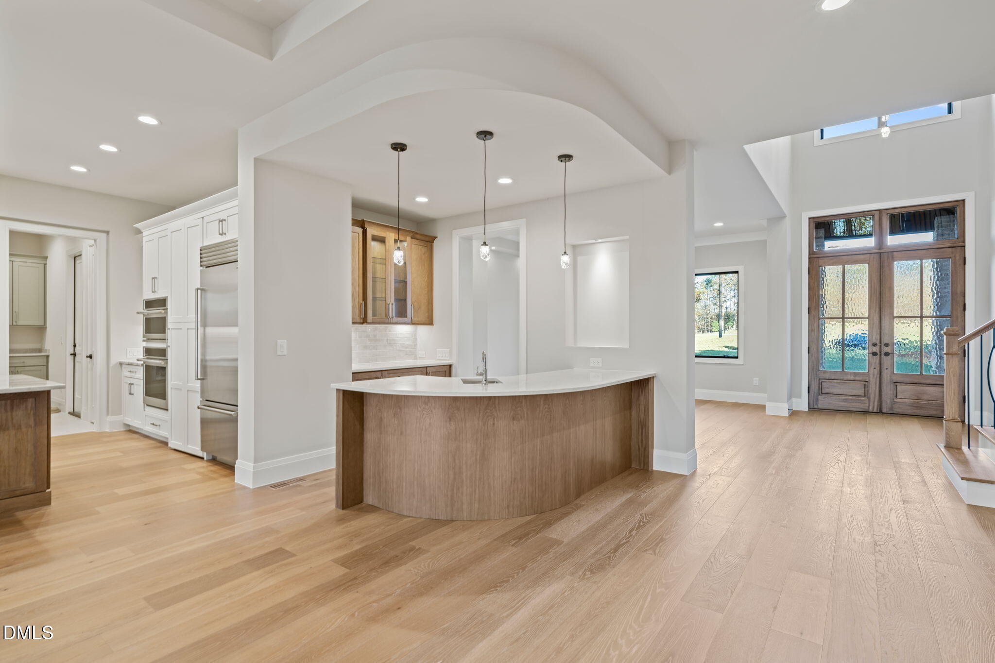9125 Overlook Crest Drive Wake Forest, NC 27587 - Photo 10 of 54 a large kitchen with stainless steel appliances kitchen island a large counter top and a wooden floors