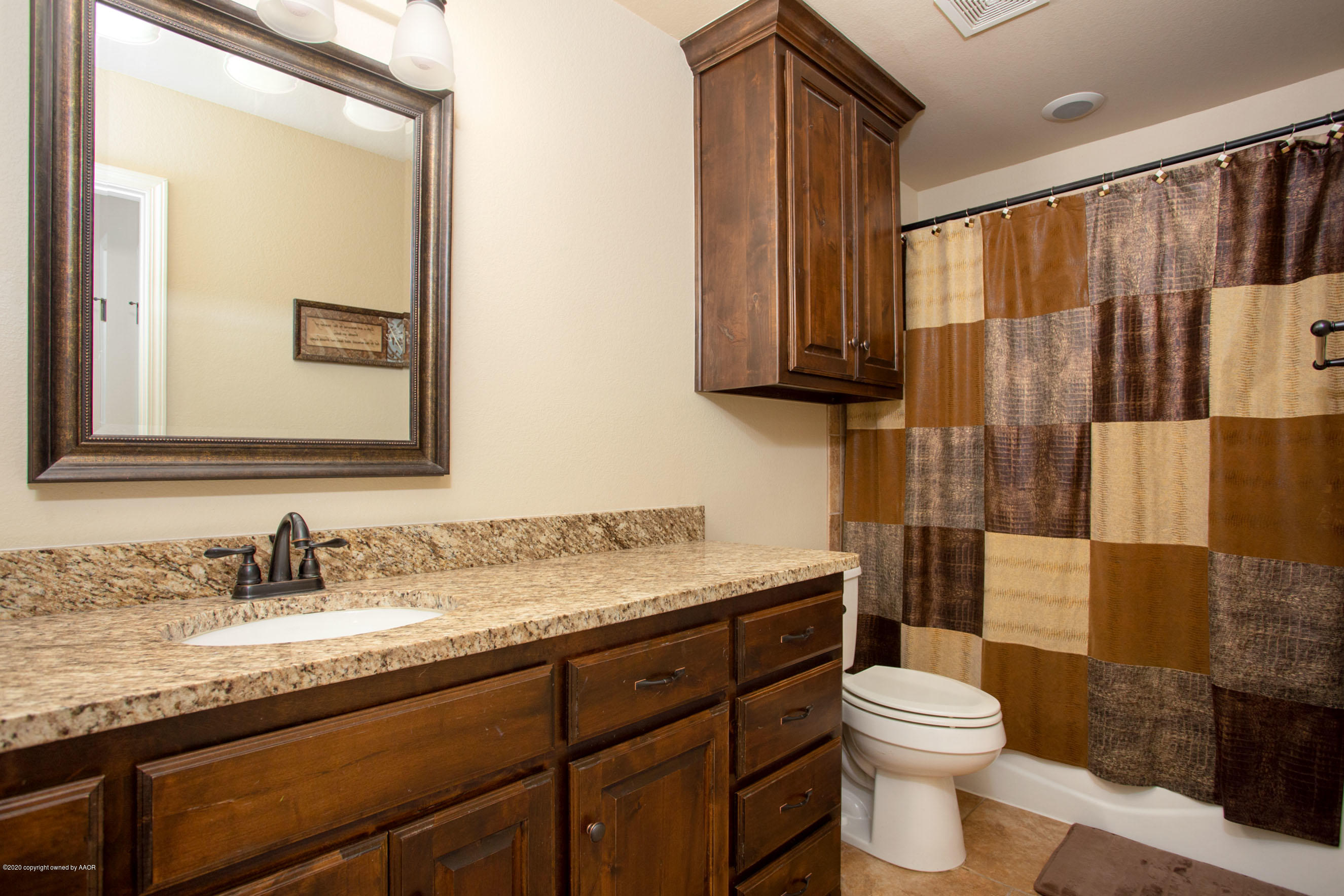 3917 Arden Road Amarillo, TX 79118 - Photo 13 of 17 a bathroom with a granite countertop sink toilet and shower