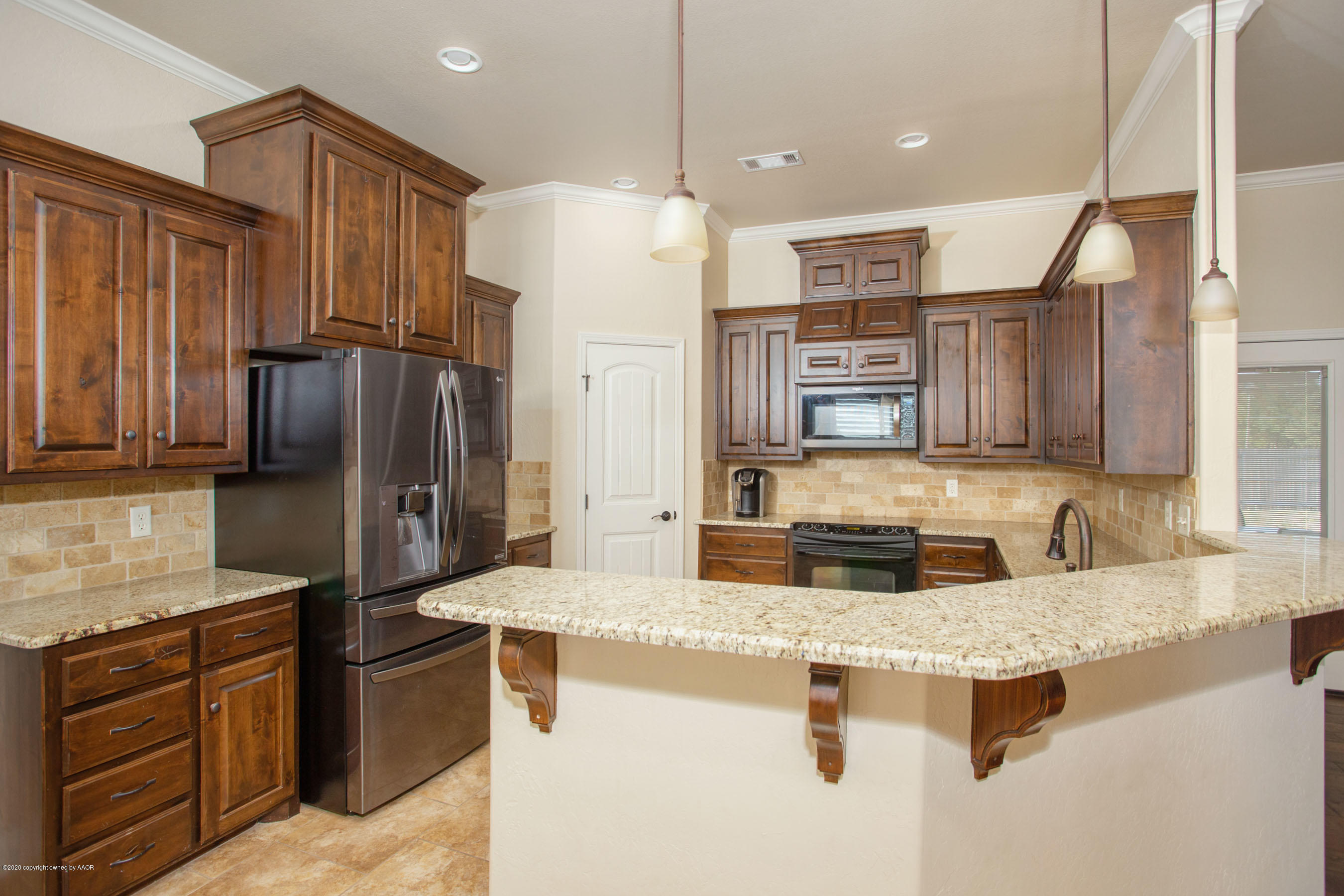 3917 Arden Road Amarillo, TX 79118 - Photo 5 of 17 a kitchen with stainless steel appliances granite countertop a sink a stove and a refrigerator