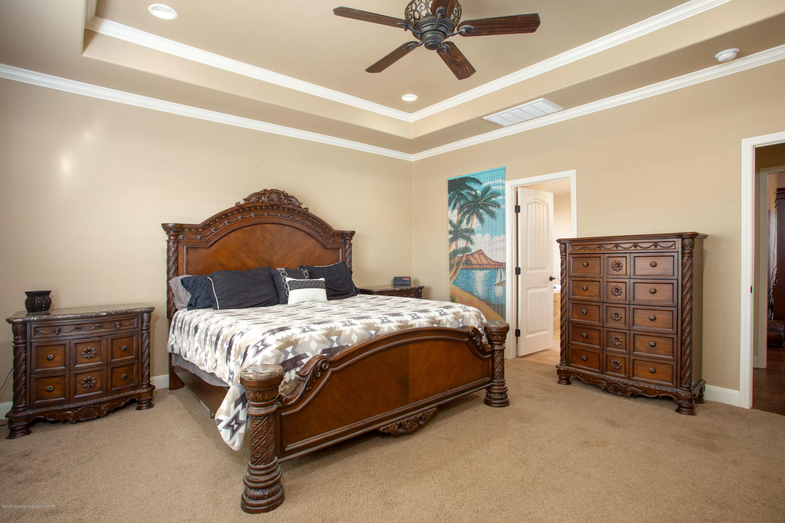 3917 Arden Road Amarillo, TX 79118 - Photo 8 of 17 a bedroom with a bed a dresser and a chandelier